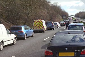 A stationery queue of traffic making a middle lane for emergency vehicles