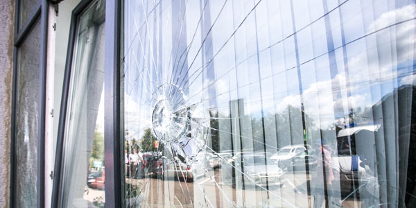 A smashed front window of a house