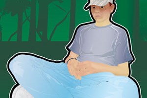 A young person looking unhappy sat against a tree truck