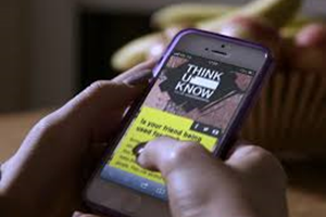 Hands holding a mobile phone that shows the Think U Know website